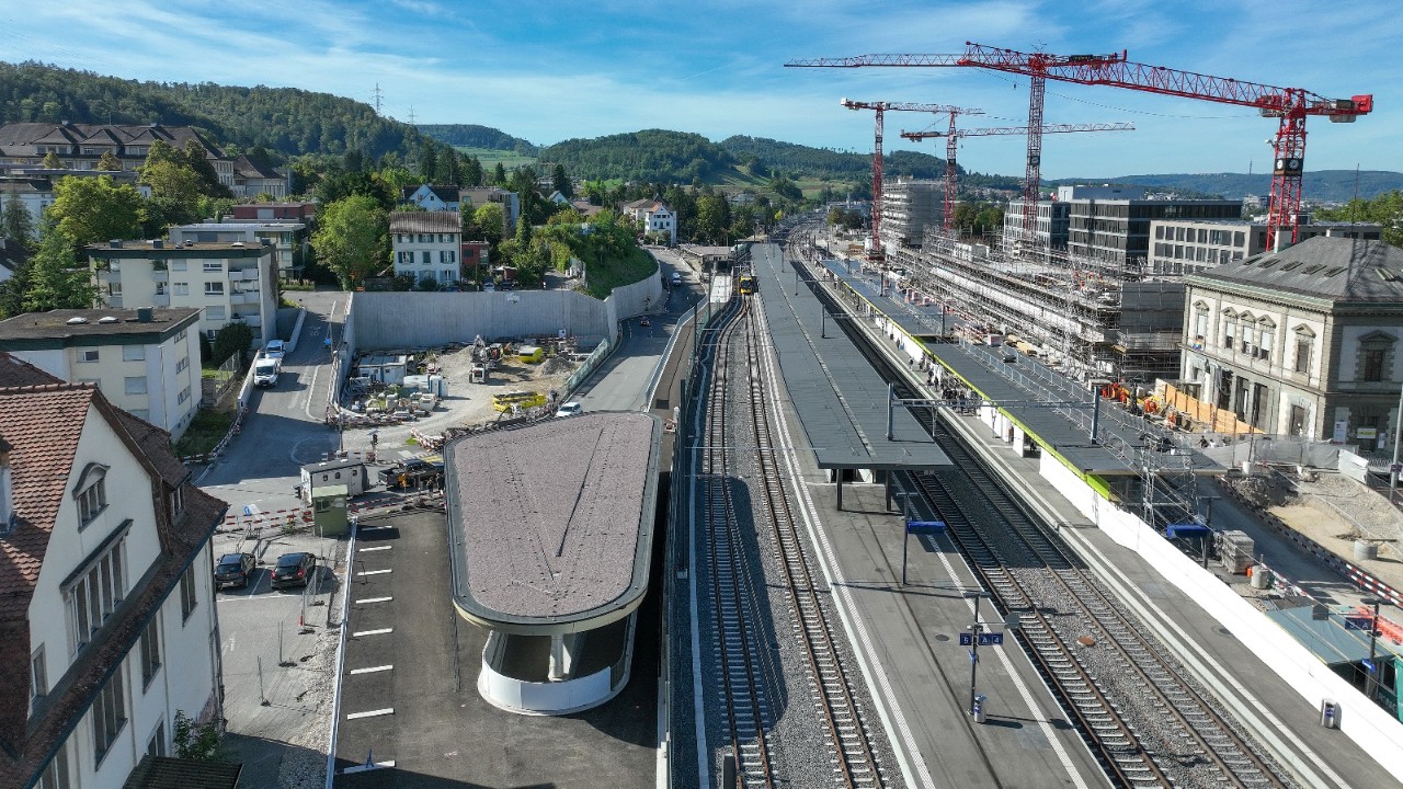 Das Foto vom September 2023 zeigt den Bahnhofs Liestal in Richtung Basel gesehen. Links der Gleise, nach dem überdachten Zugang zur Personenunterführung Oristal, befindet sich die Fläche, auf der das Bauteam das P+Rail-Parkhaus Tiergartenstrasse erstellt.