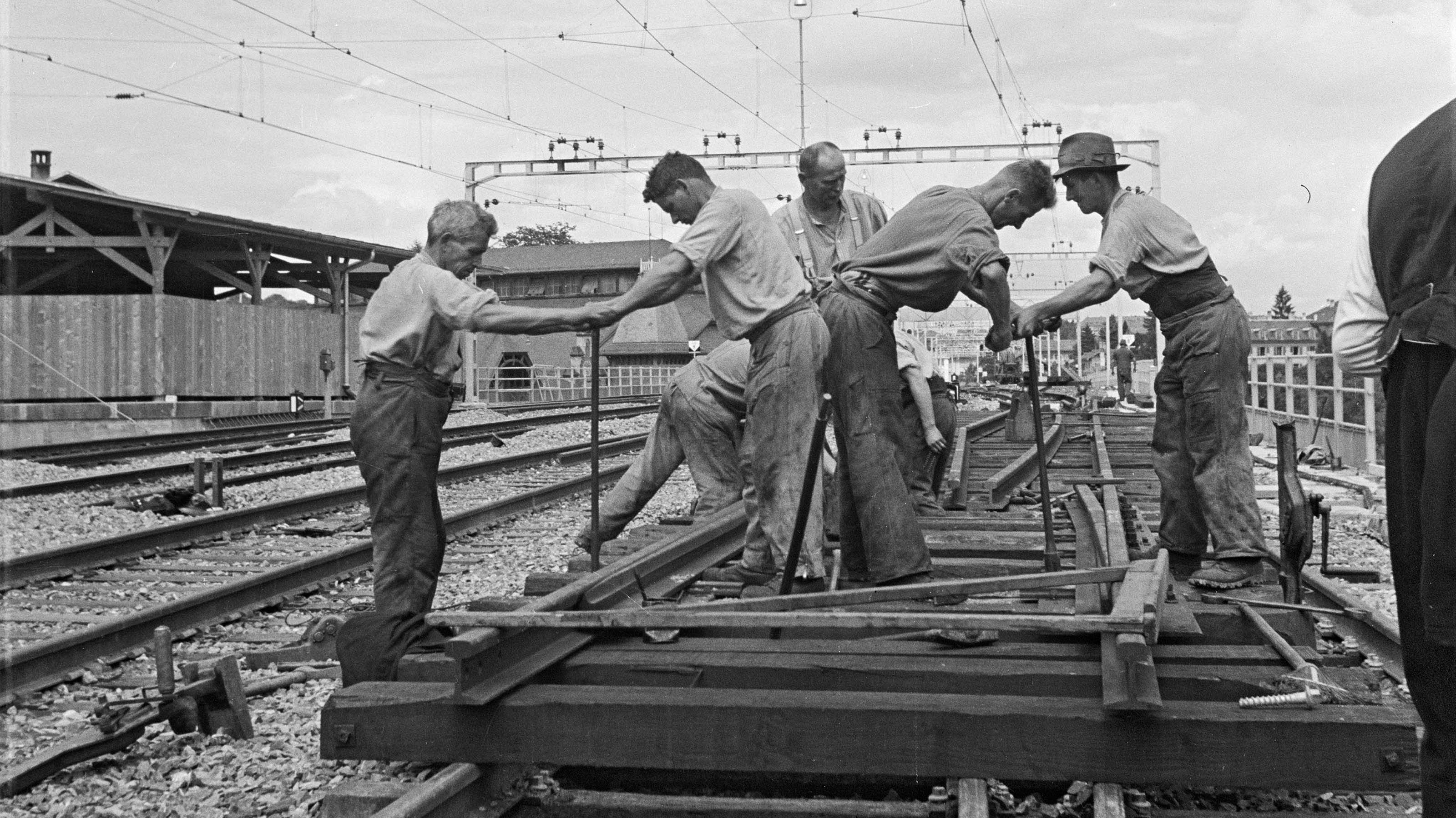 Black and white photograph of railway workers in the track area in 1941.