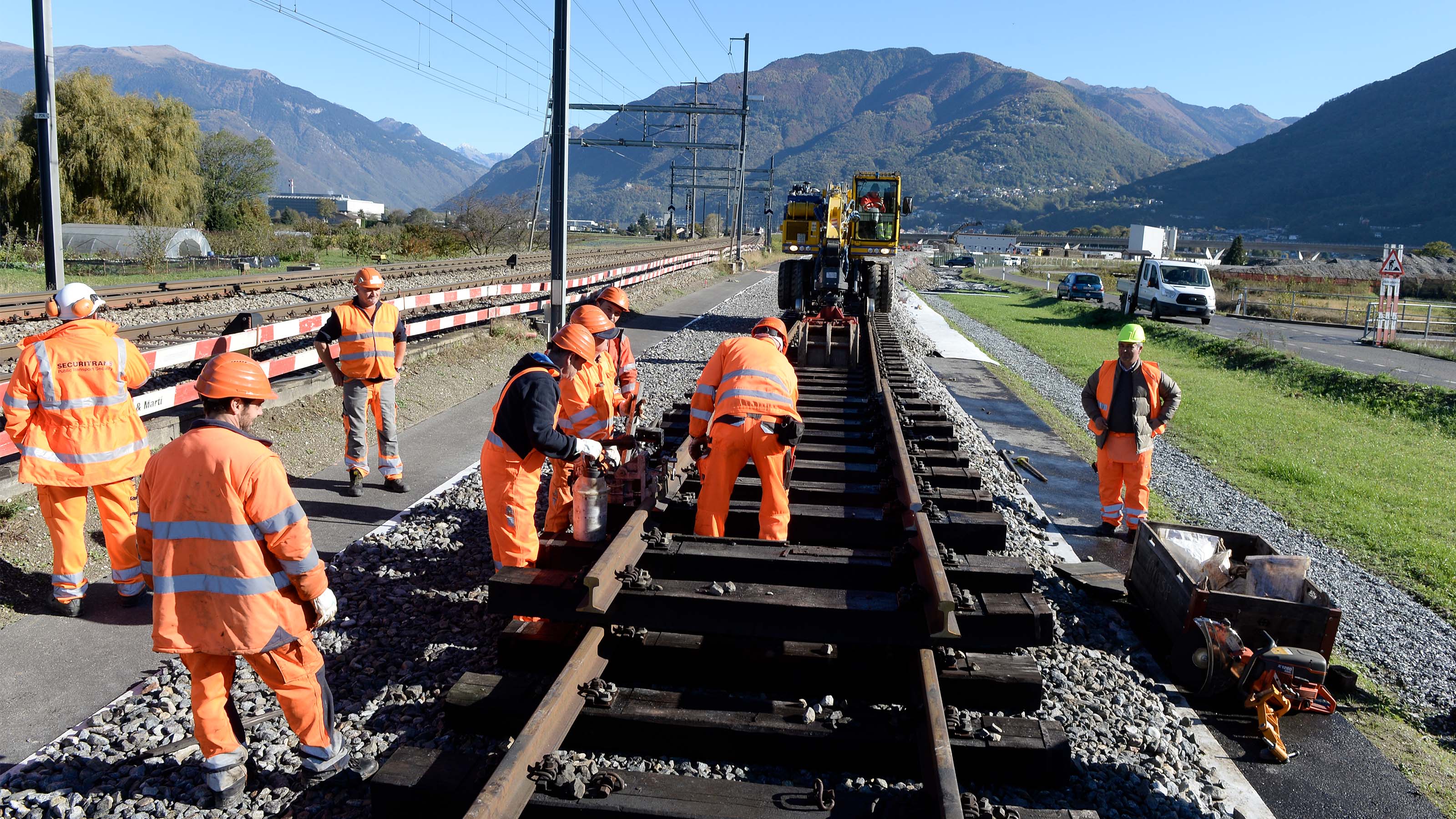 Workers in protective orange clothing in the track area, 2016.