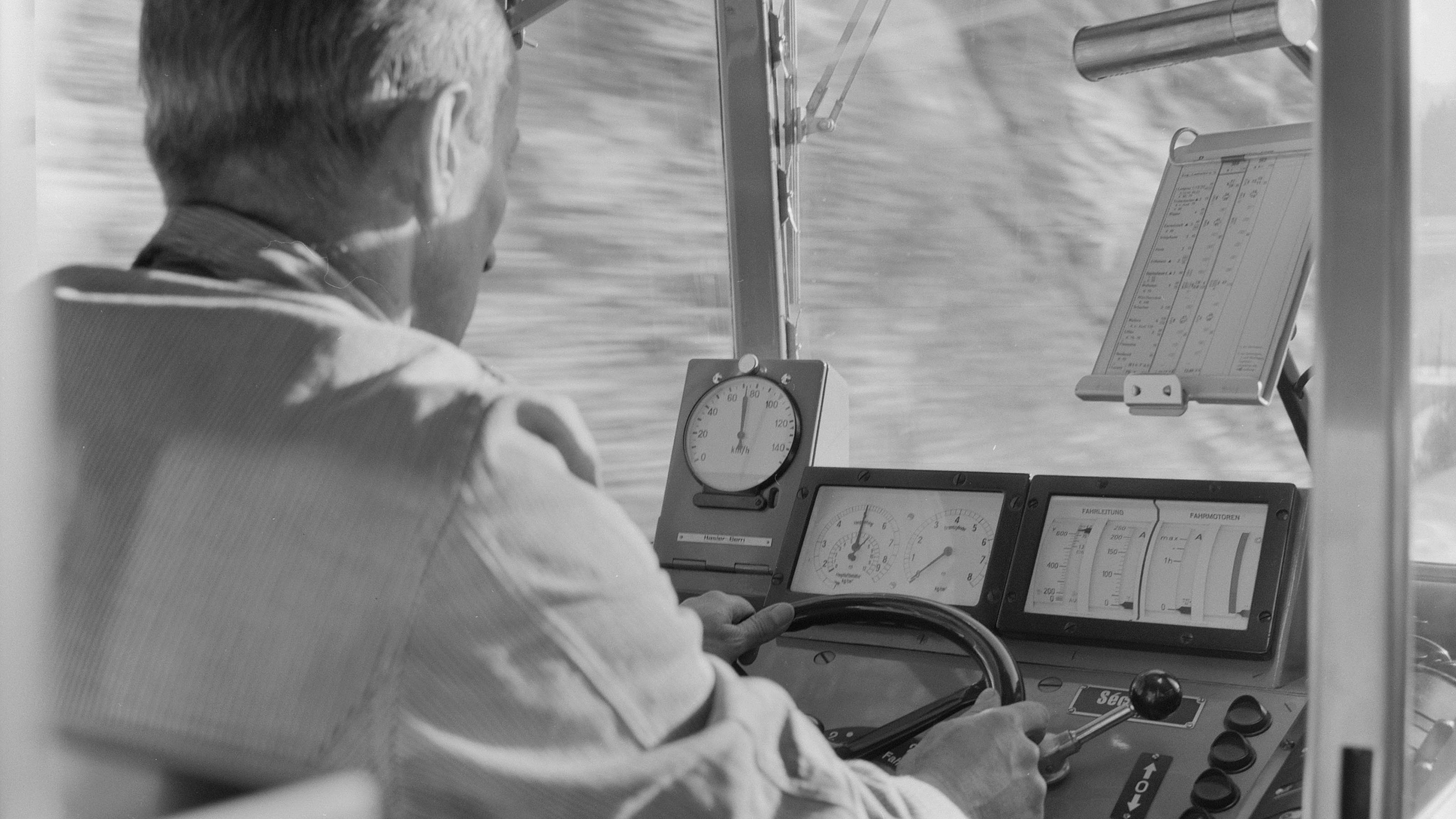 Black and white close-up from the rear of an engine driver’s cab, 1960.