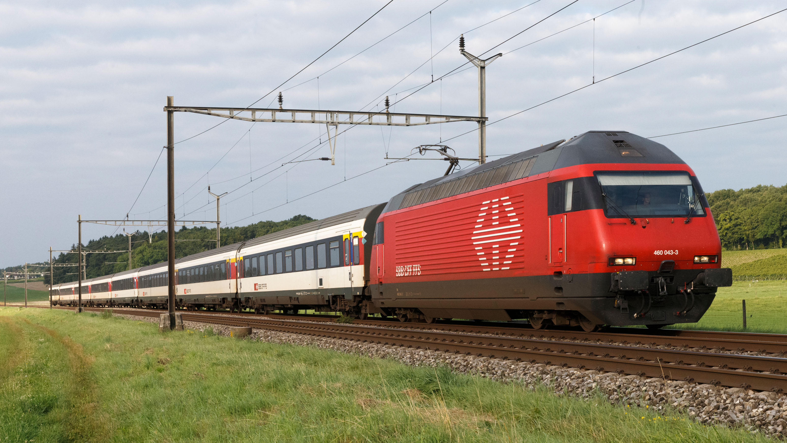 A passenger train travelling along a railway line, 2014.